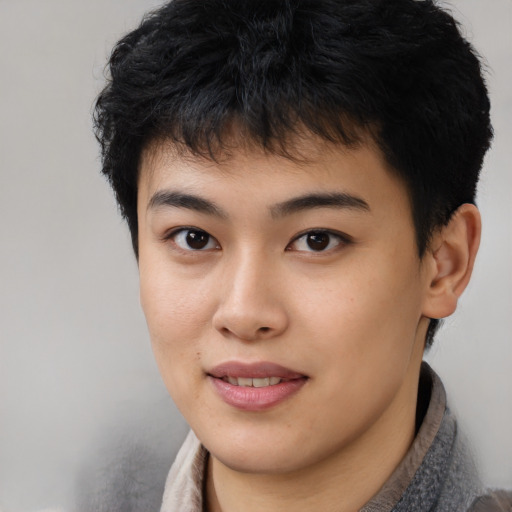 Joyful asian young-adult male with short  black hair and brown eyes