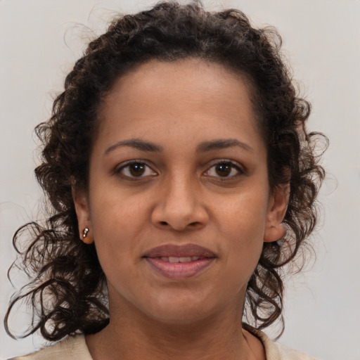 Joyful black young-adult female with medium  brown hair and brown eyes