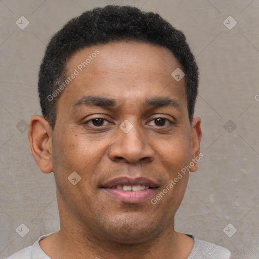 Joyful black young-adult male with short  brown hair and brown eyes