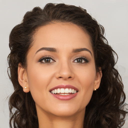 Joyful white young-adult female with long  brown hair and brown eyes