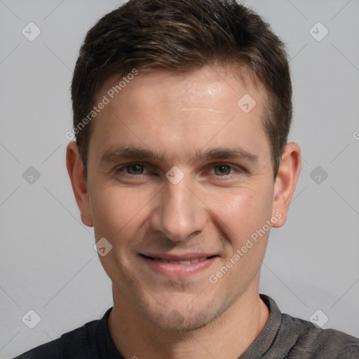 Joyful white adult male with short  brown hair and grey eyes