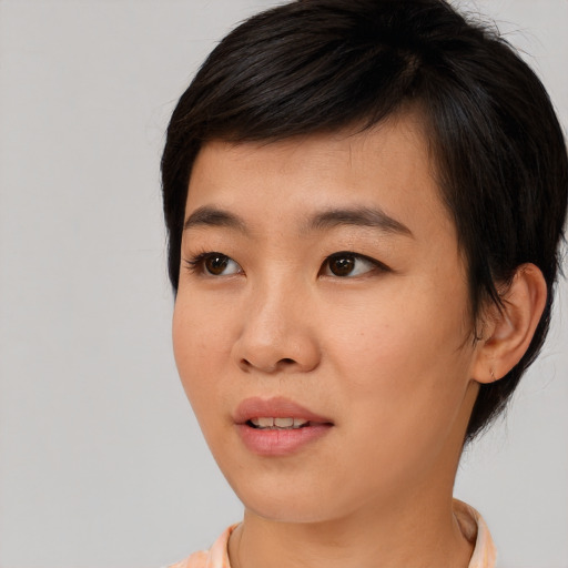 Joyful asian young-adult female with short  brown hair and brown eyes