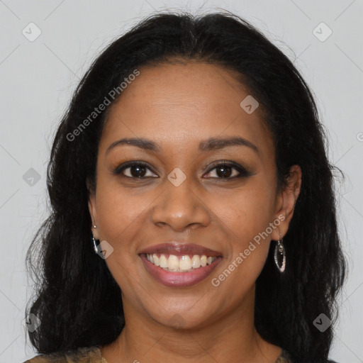 Joyful black young-adult female with long  brown hair and brown eyes