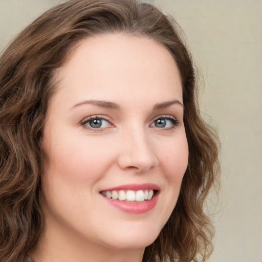 Joyful white young-adult female with long  brown hair and green eyes