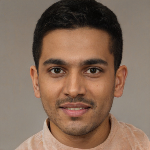 Joyful latino young-adult male with short  black hair and brown eyes