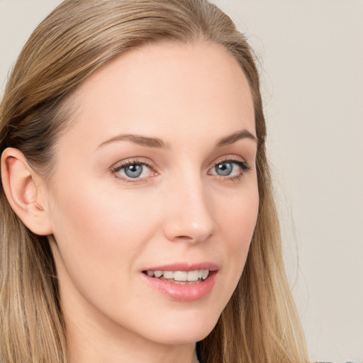 Joyful white young-adult female with long  brown hair and blue eyes