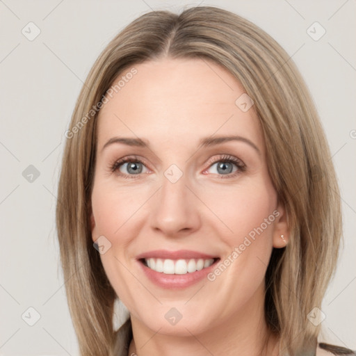 Joyful white young-adult female with medium  brown hair and blue eyes