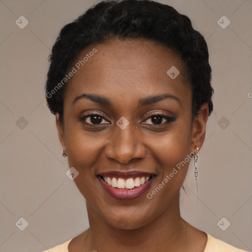 Joyful black young-adult female with short  black hair and brown eyes