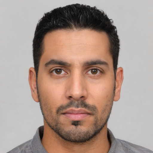 Neutral latino young-adult male with short  black hair and brown eyes