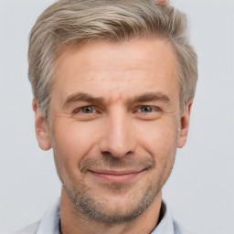 Joyful white adult male with short  brown hair and grey eyes