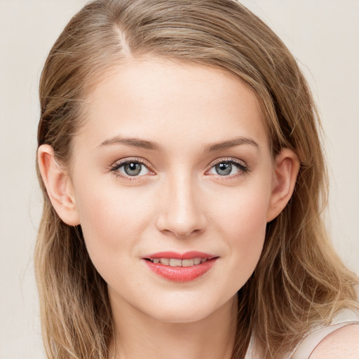 Joyful white young-adult female with long  brown hair and blue eyes