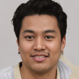 Joyful asian young-adult male with short  black hair and brown eyes