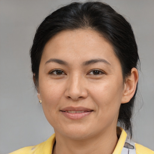 Joyful asian adult female with medium  brown hair and brown eyes