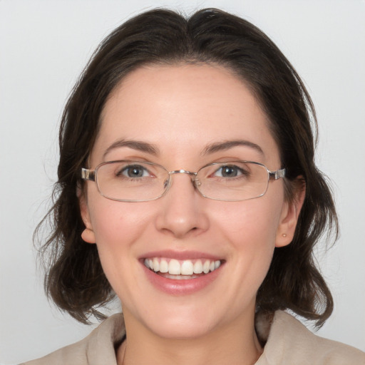 Joyful white adult female with medium  brown hair and grey eyes