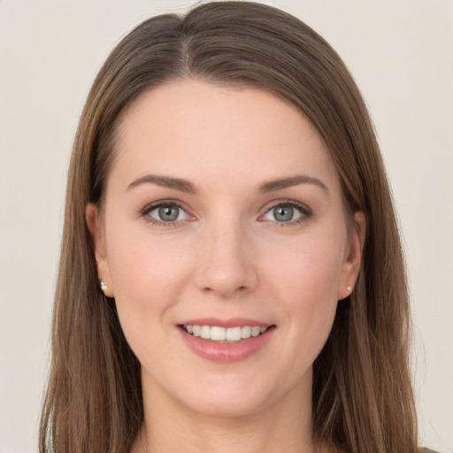 Joyful white young-adult female with long  brown hair and grey eyes