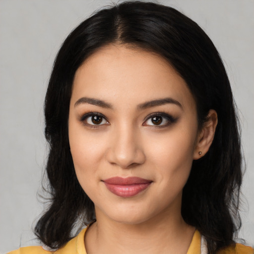 Joyful latino young-adult female with medium  black hair and brown eyes