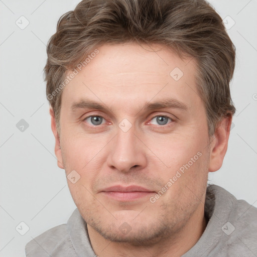 Joyful white adult male with short  brown hair and grey eyes