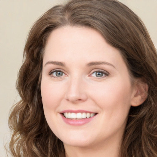 Joyful white young-adult female with long  brown hair and green eyes