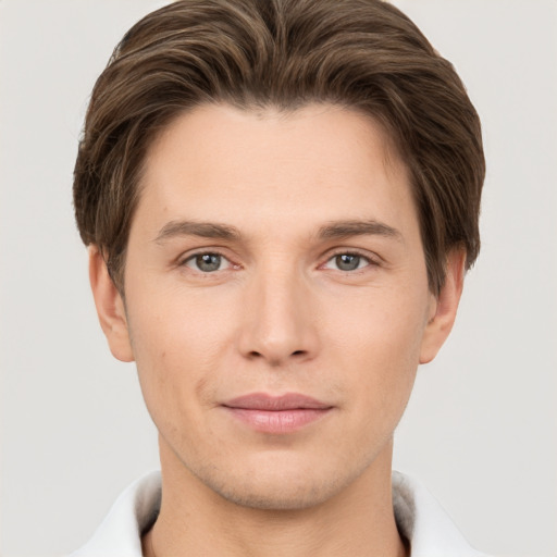 Joyful white young-adult male with short  brown hair and grey eyes