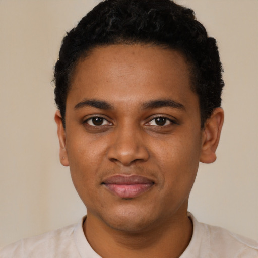 Joyful black young-adult male with short  black hair and brown eyes