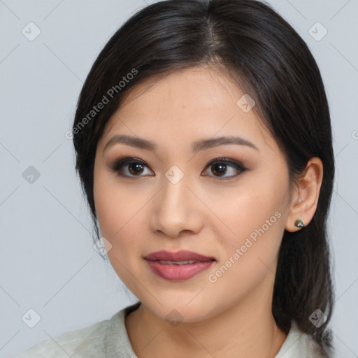 Joyful latino young-adult female with medium  brown hair and brown eyes