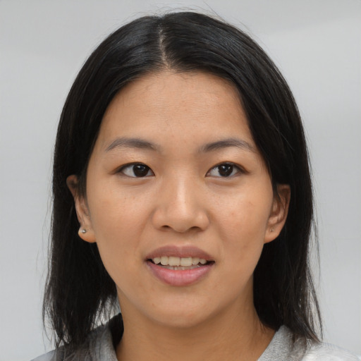 Joyful asian young-adult female with medium  black hair and brown eyes
