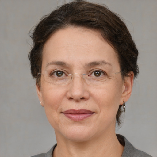 Joyful white adult female with short  brown hair and grey eyes