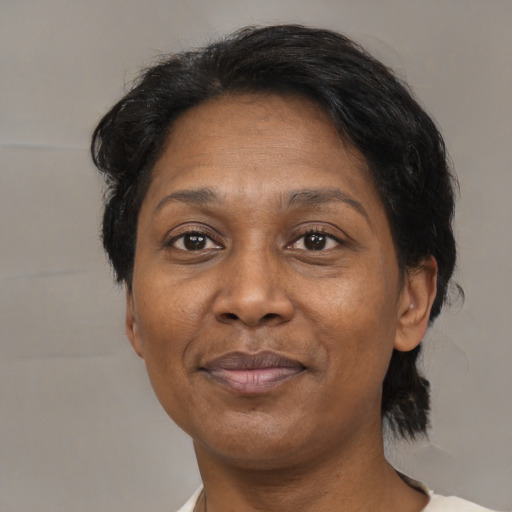 Joyful black adult female with medium  black hair and brown eyes