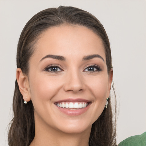 Joyful white young-adult female with long  brown hair and grey eyes