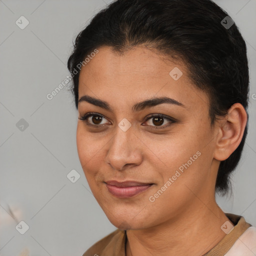 Joyful latino young-adult female with medium  brown hair and brown eyes