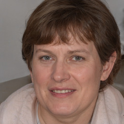 Joyful white adult female with medium  brown hair and grey eyes