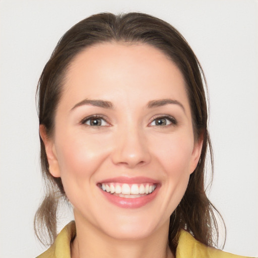 Joyful white young-adult female with medium  brown hair and brown eyes