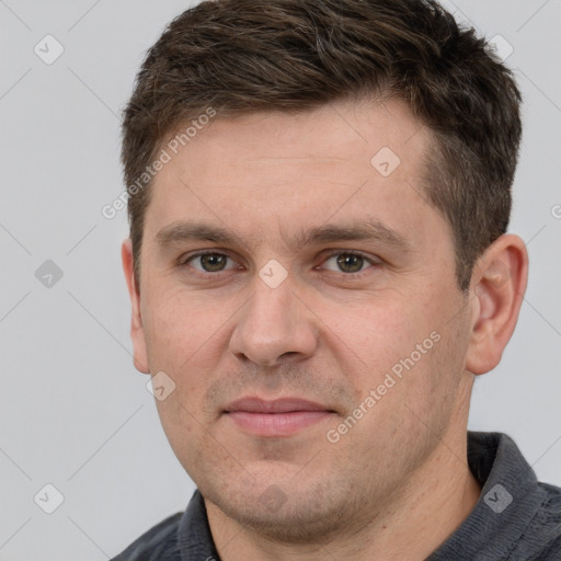 Joyful white adult male with short  brown hair and grey eyes