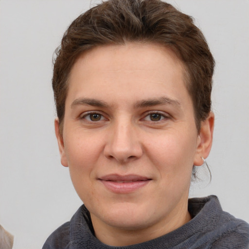 Joyful white young-adult female with short  brown hair and grey eyes