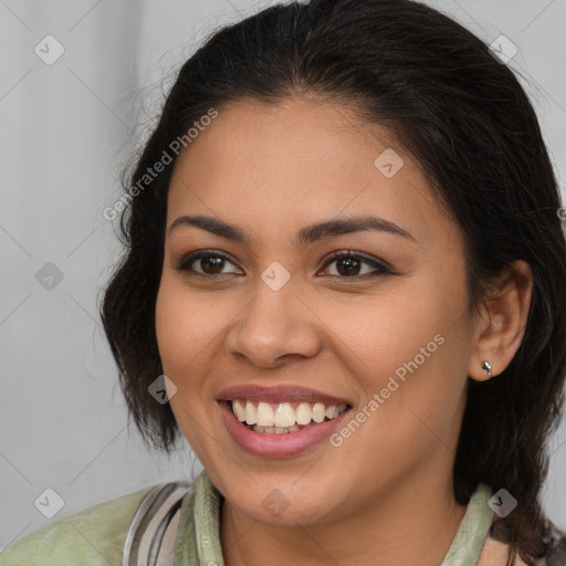 Joyful latino young-adult female with medium  brown hair and brown eyes