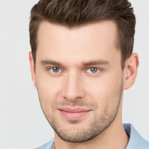 Joyful white young-adult male with short  brown hair and brown eyes