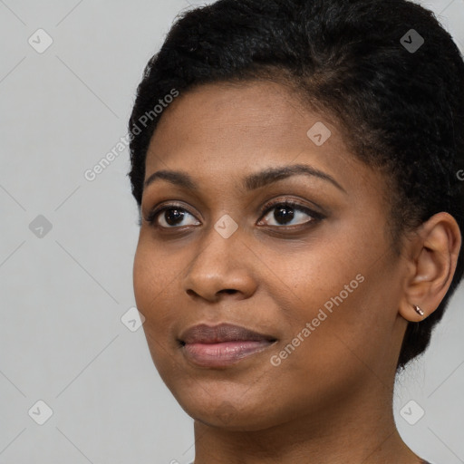 Joyful black young-adult female with short  black hair and brown eyes