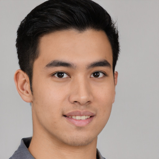 Joyful latino young-adult male with short  brown hair and brown eyes