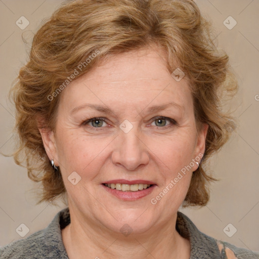 Joyful white adult female with medium  brown hair and blue eyes