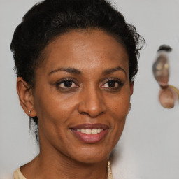 Joyful black adult female with short  brown hair and brown eyes