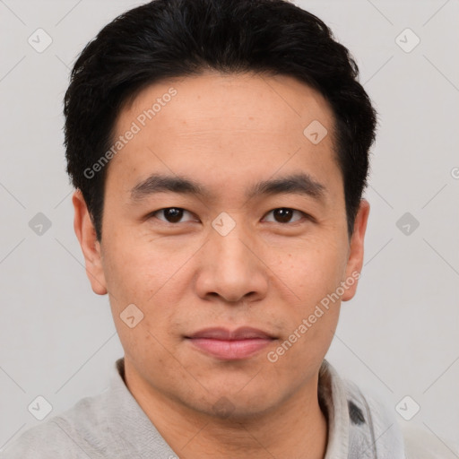 Joyful asian young-adult male with short  black hair and brown eyes