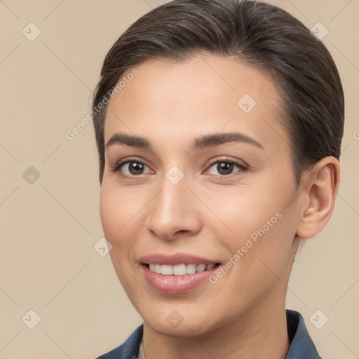 Joyful white young-adult female with short  brown hair and brown eyes