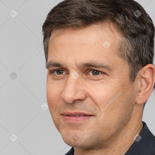 Joyful white adult male with short  brown hair and brown eyes