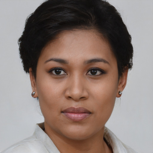Joyful latino young-adult female with short  brown hair and brown eyes