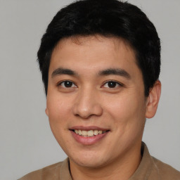 Joyful asian young-adult male with short  brown hair and brown eyes