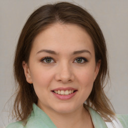 Joyful white young-adult female with medium  brown hair and green eyes