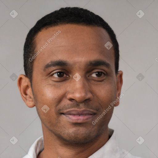Joyful black young-adult male with short  brown hair and brown eyes