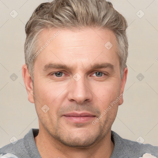 Joyful white adult male with short  brown hair and grey eyes