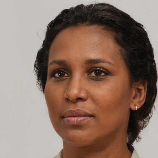 Neutral black young-adult female with medium  brown hair and brown eyes