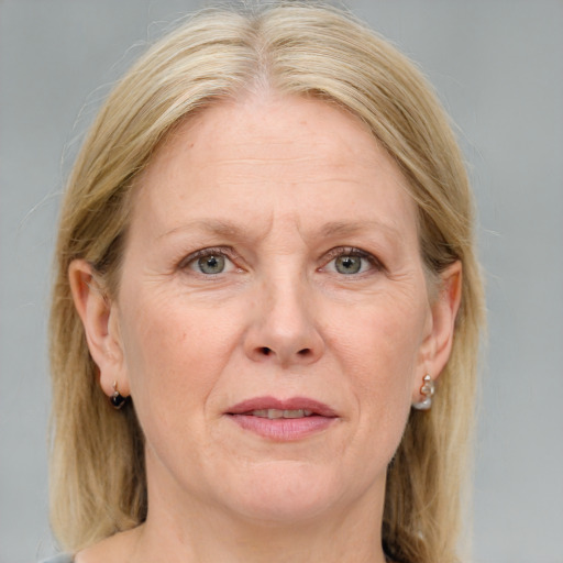 Joyful white middle-aged female with medium  brown hair and blue eyes